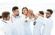 © ASDF - group of doctors giving each other a high five.