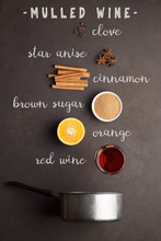 Ingredients For Recipe Of Mulled Wine With Text On Brown Stone Background.