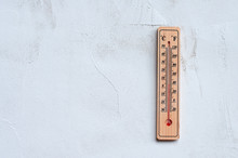 Thermometer On A Gray Wall