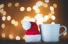 White Cup Of Tea Or Coffee And Santa Claus Hat