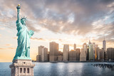 Fototapeta  - The Statue of Liberty with Lower Manhattan background in the evening at sunset, Landmarks of New York City, USA