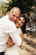 © IVASHstudio - Cheerful adult wedding couple walks around the city in a sunny day
