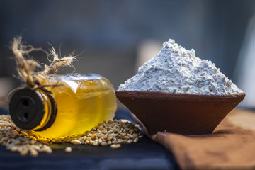 Triticum,wheat flourwith seeds and a bottle of common cooking oil.