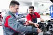 © NDABCREATIVITY - Car mechanics working at automotive service center