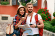 © puhhha - Couple Of Travelers Using Map For Sightseeing In Town.
