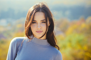 Girl with long brunette hair enjoy autumn nature