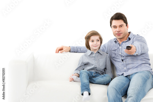 Family Of Two People Father And Son On The Couch With A Remote