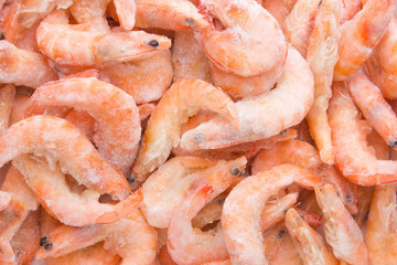 Frozen shrimps in ice. A lot of royal shrimp close-up.