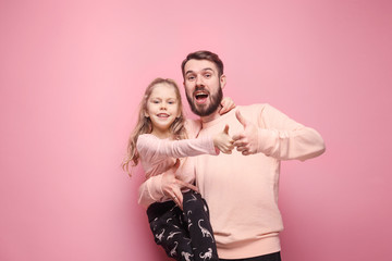 Wall Mural - Young father with his baby daughter with thumb up