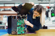 © NDABCREATIVITY - Young woman engineer working on robotics project