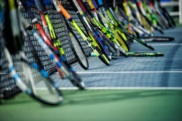tennis rackets or tennis racquets leaning against tennis court background