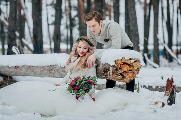  Stylish couple are posing in snowy forest. Winter wedding. Artwork