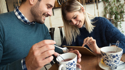 Happy young couple on date in coffee shop