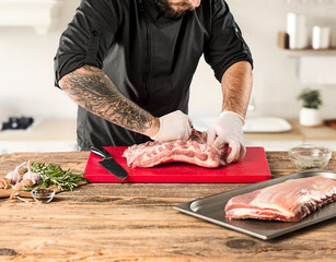 Wall Mural - Man cooking meat steak on kitchen