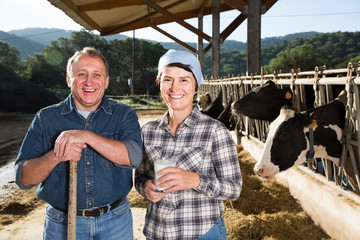 male and female workers posing on cow farm