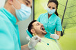 © zorandim75 - Dentists examining and working on male patient.Dentist's office.