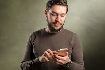 Relaxed young casual man reading text message