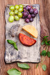 © Przemek Klos - Cheese and grapes on handmade pottery plate