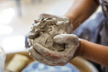 Female Potter Hands Knead Wet White Clay
