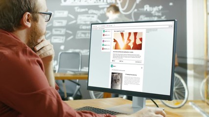 Wall Mural - creative office worker browsing social network pages, he scrolls through his wall on a personal comp