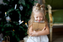 Happy Cute Little Smiling Girl With Christmas Gift Box. Merry Christmas And Happy Holidays.