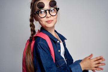 Wall Mural - a young girl with glasses is having fun