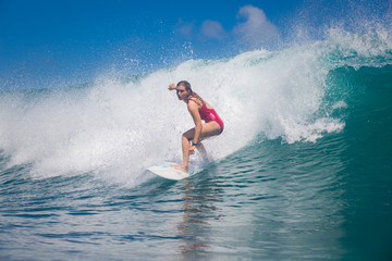Wall Mural - indonesia, bali, july 23 2016: a female surfer, leonor fragoso riding big blue ocean surfing wave, s