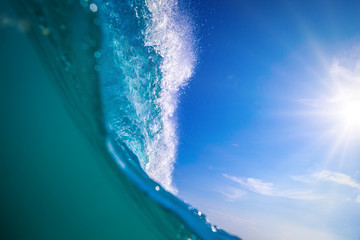 Wall Mural - big ocean surfing wave split view from water surface