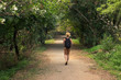 © HD92 - one young man back, rear view, outdoor walking thought forest vacation.