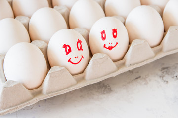 Enamored eggs in a box. Eggs with painted faces