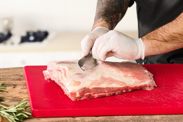 Wall Mural - Man cooking meat steak on kitchen