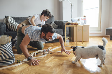 Father and Son Playing With Dog