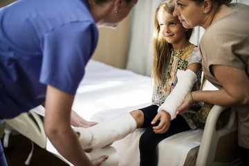 Young Caucasian girl with broken arm in plaster cast