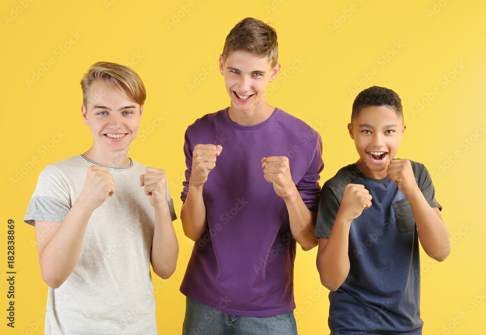 Cute teenagers on color background