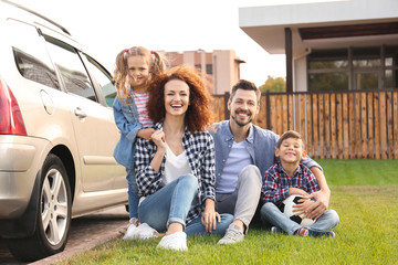 Canvas Print - Young family with children near car, outdoors