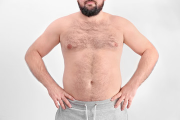 Poster - Overweight young man on light background