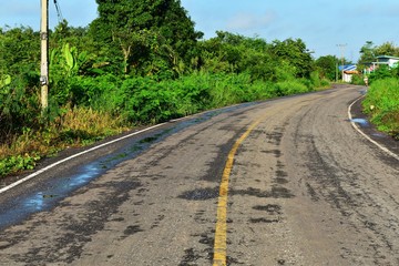 Canvas Print - wet and old asphalt road in countryside in thailand