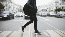 Modern Young Bearded Man In Black Style Clothes Is Walking At Street.