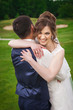 © luckyphoto - Beautiful bride and handsome groom on wedding day. Young newlyweds smiling in green nature. Concept of happy moment