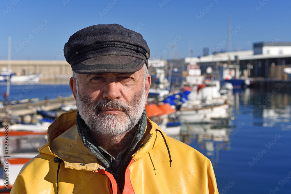 portrait of a fisherman in the harbor - obrazy, fototapety, plakaty 