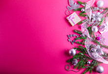Pink Christmas Background With A Present And Decorations