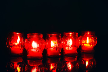 Wall Mural - Holders with burning candles on dark background