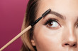 © Drobot Dean - Cropped photo of young lady paint eyebrow with brush isolated