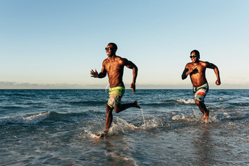 Wall Mural - Two cuban friends having fun in the beach.