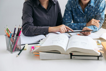 Wall Mural - tutor books with friends, young students campus or classmates helps friend catching up workbook and 