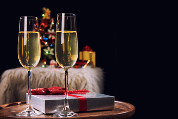 Happy Relaxing at party, Two champagne glasses and sparkle, Christmas tree ornament on the background