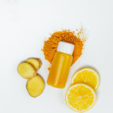 Fototapeta Do pokoju - Ginger shot healthy drink with curd in a plastic bottle on white background. Immunity Boosting Tonic. Top view