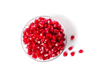 Pomegranate fruits in a bowl on white background