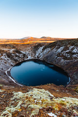 Top view of the Kerid crater with blue lake at sunrise. The Golden Circle tour. Iceland landscape.