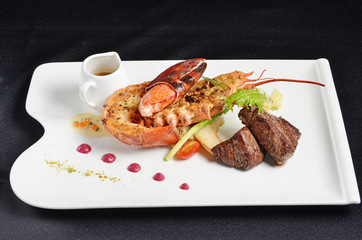 Grilled beef meat with lobster and sauce on white plate